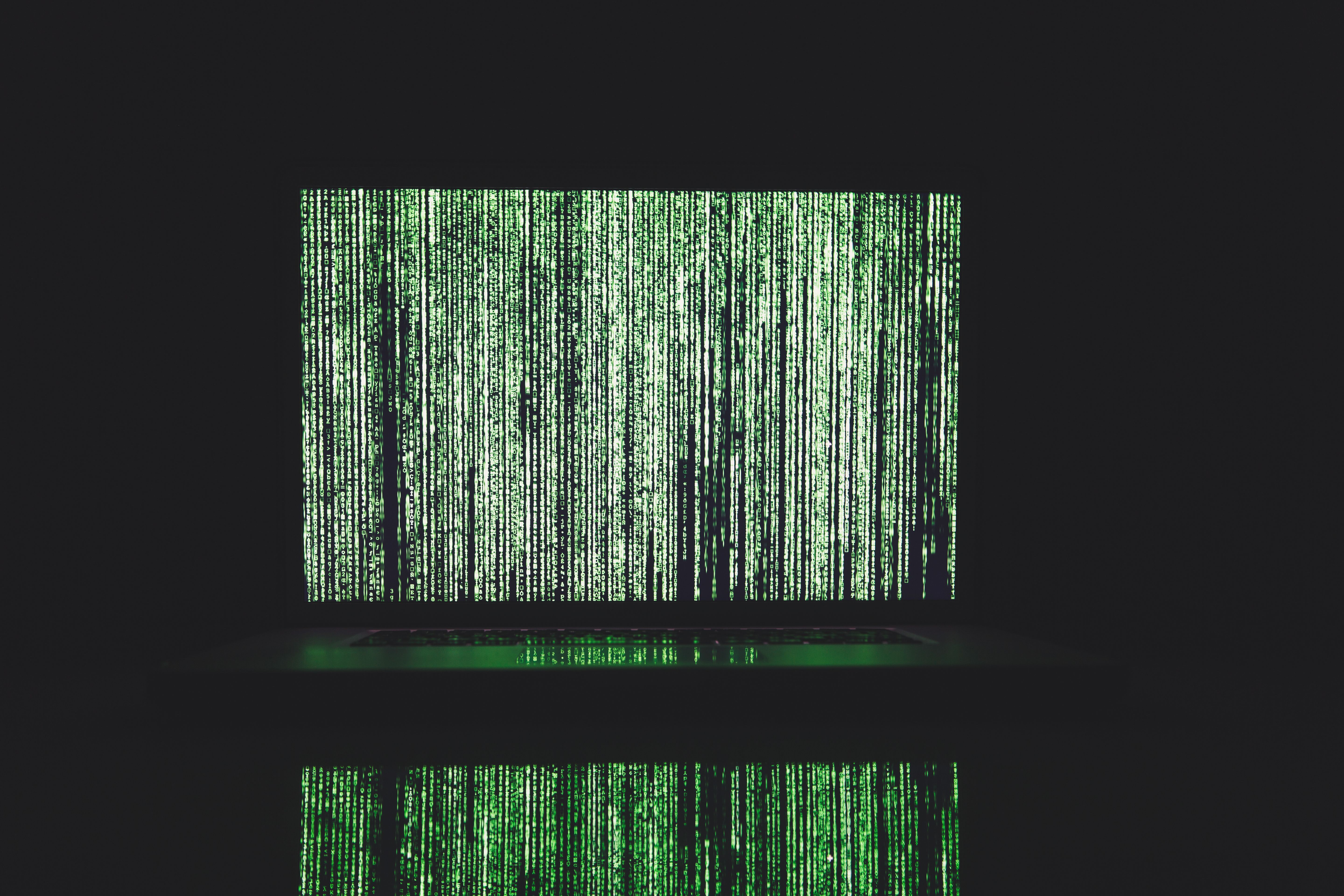 Abstract green matrix-style code on a screen, representing AI detection algorithms