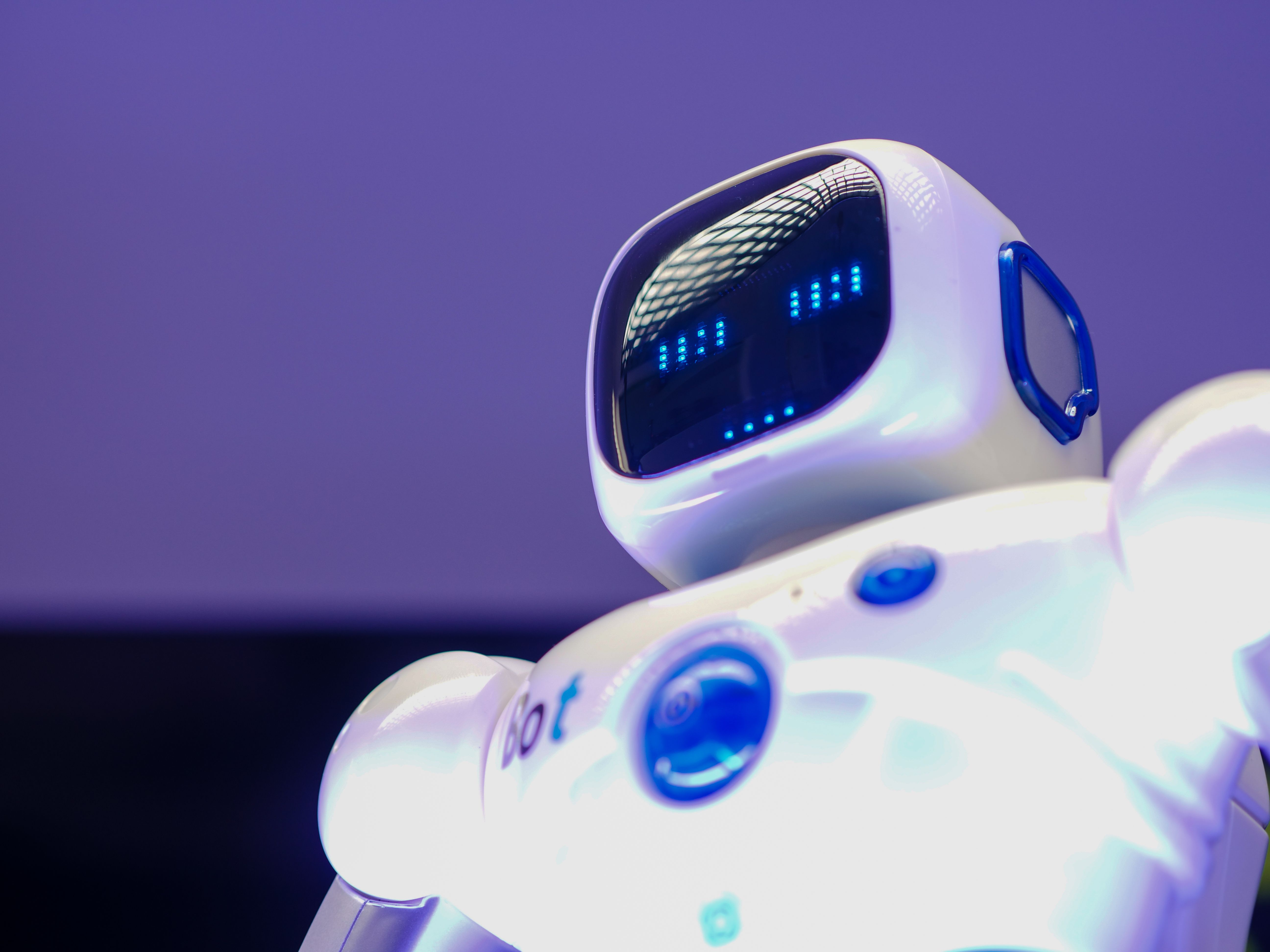 Humanoid robot with a digital face, symbolizing AI-generated content